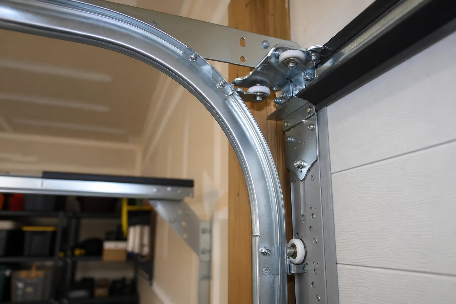 Newly aligned garage door track and quiet rollers