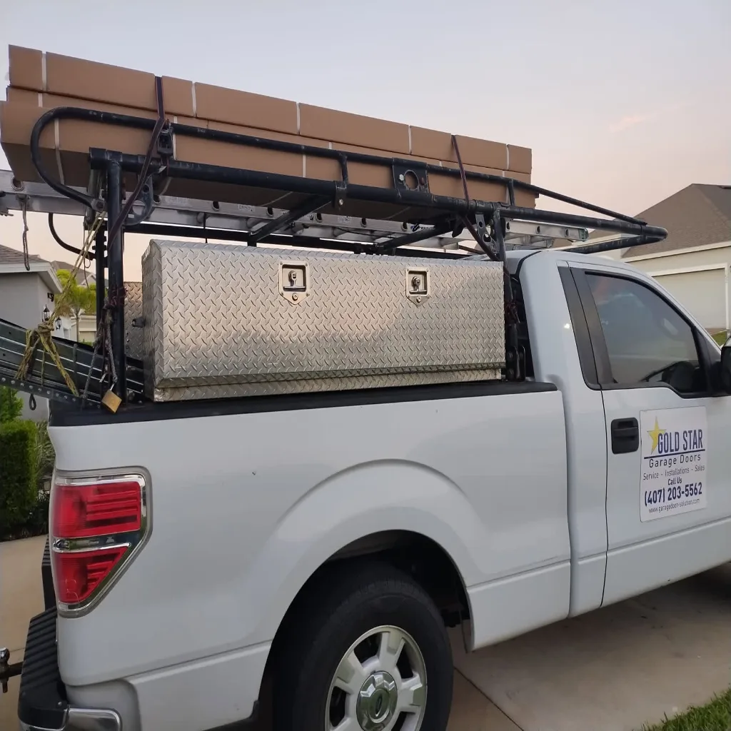 Gold Star Garage Doors truck loaded with door sections on the way to an installation