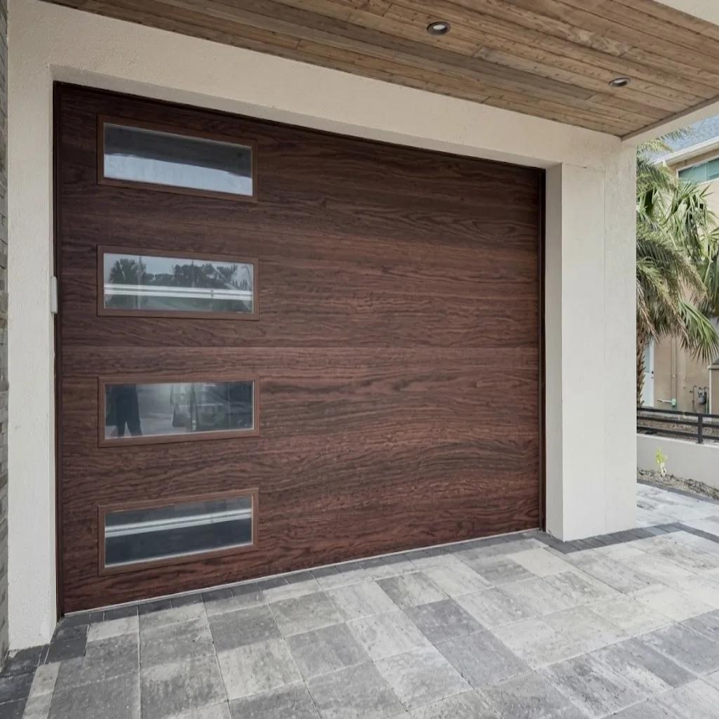 Newly installed modern wood-look garage door with horizontal windows